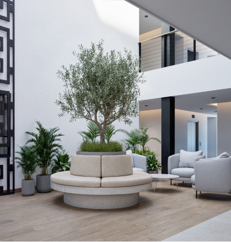 Lobby de doble altura con olivo central en Campestre Views